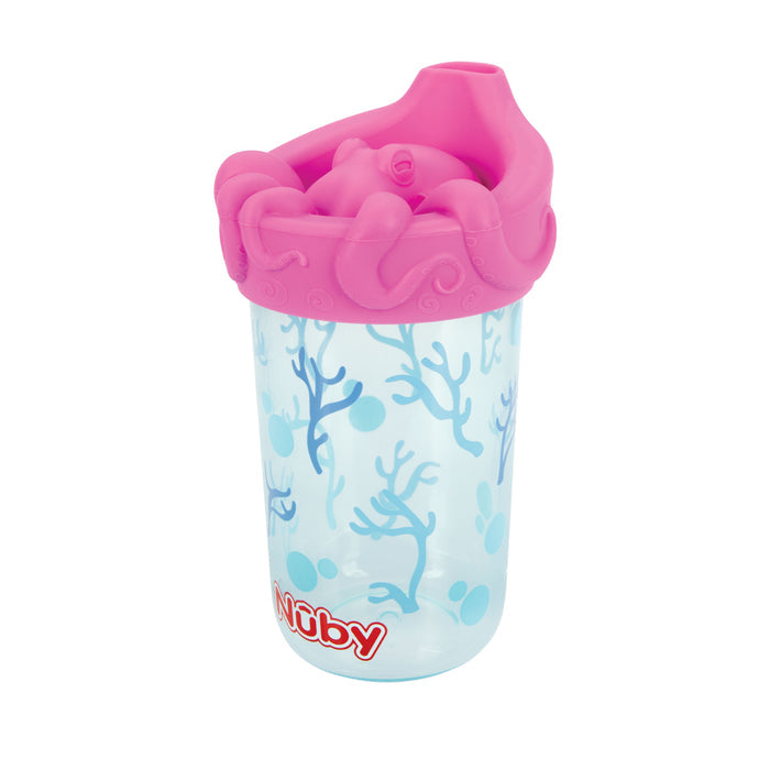 The Nuby 3D Character Soft Spout Sippy Cup | Pink Octopus features blue coral designs, a pink octopus-shaped lid, and a red and white Nuby logo. Its leak-resistant design ensures confident use.