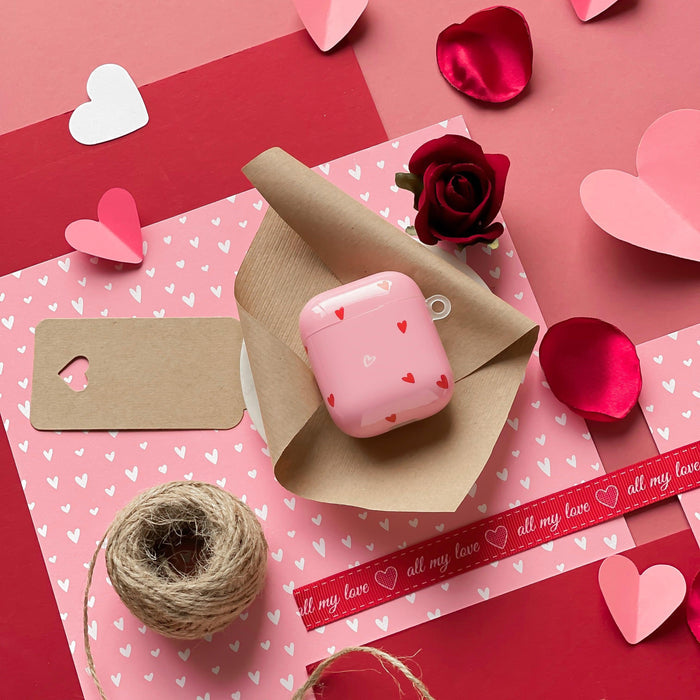Pink AirPods case with hearts, rose and ribbon pattern in flexible TPU material.