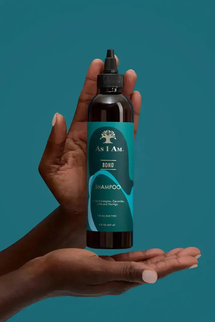 As I Am Bond Shampoo held in hands, an ideal bond-strengthening technology for curly, coily, and wavy hair types.
