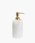 Elegant soap dispenser with a ribbed white marble base and a shiny gold pump. The design conveys luxury and sophistication in a minimalistic style. | Wildwood Home Co.