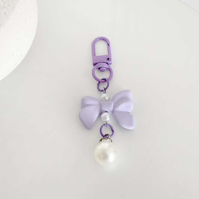 Lilac bow keyring with pearl beads and a faux pearl charm, by Coconut Lane.