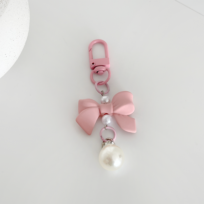 Peach pink bow keyring with two small pearls and a large pearl charm from Coconut Lane.