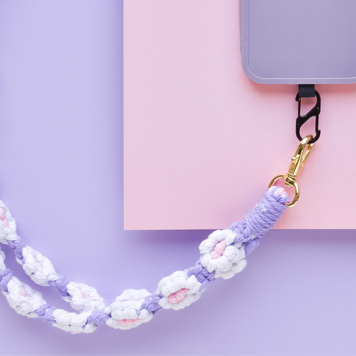 Lilac crochet flower phone lanyard bundle displayed on a pink and purple background.