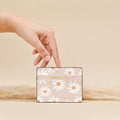 Coconut Lane Daisy Chain card holder with daisy pattern, held in hand against a beige background.