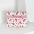 Pink and white card holder with cherry and heart patterns, finished with gold Coconut Lane branding on top.