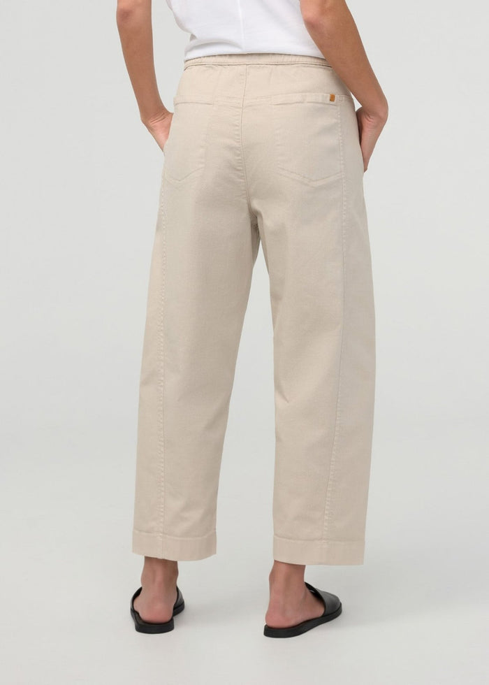 Sandstone pull-on pants with barrel leg, elastic waistband, side pockets, and cropped length, shown from back view.