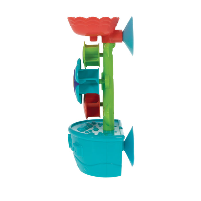 The Nuby Flow N' Grow Bath Toy features a blue base, green stem, red top funnel, and multicolored spinning wheels. Large suction cups secure it to surfaces. Side view shown. Designed to encourage motor skills during bath time fun.