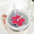 Pink Stanley 40oz tumbler with straw, topped with a lilac and pink floral silicone lid topper and a matchstick.