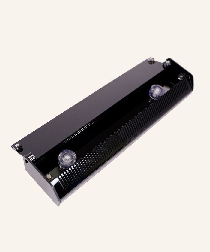 The Perfect Locks Hair Extension Detangling Caddy is a black, rectangular organizer with ridged edges and two clear suction cups.#color_black