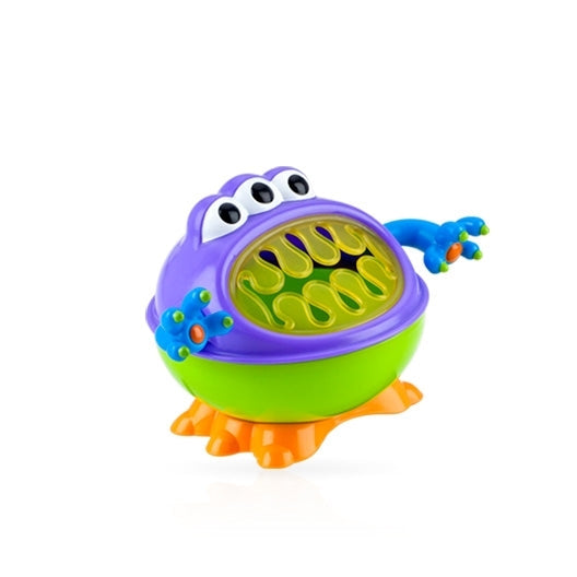 The Nuby iMonster Snack Keeper, shown against a white background, is a playful kids’ cup featuring three eyes, a big mouth with yellow spirals, blue arms with orange and green spots, a purple and green body, and orange feet.