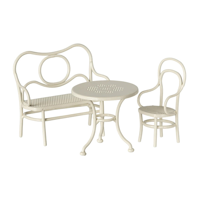 White metal outdoor furniture set with bench, table, and chair on a white background