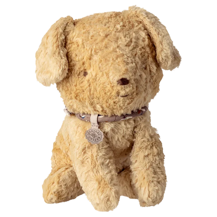 Beige stuffed dog toy with a collar on a white background