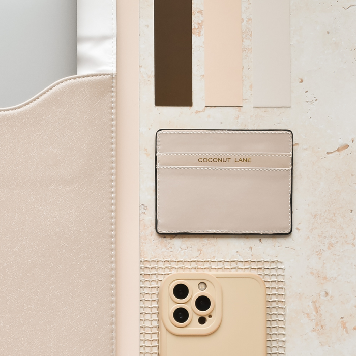 NAKD Nude card holder by Coconut Lane, displayed with fabric and color swatches on a light stone background.