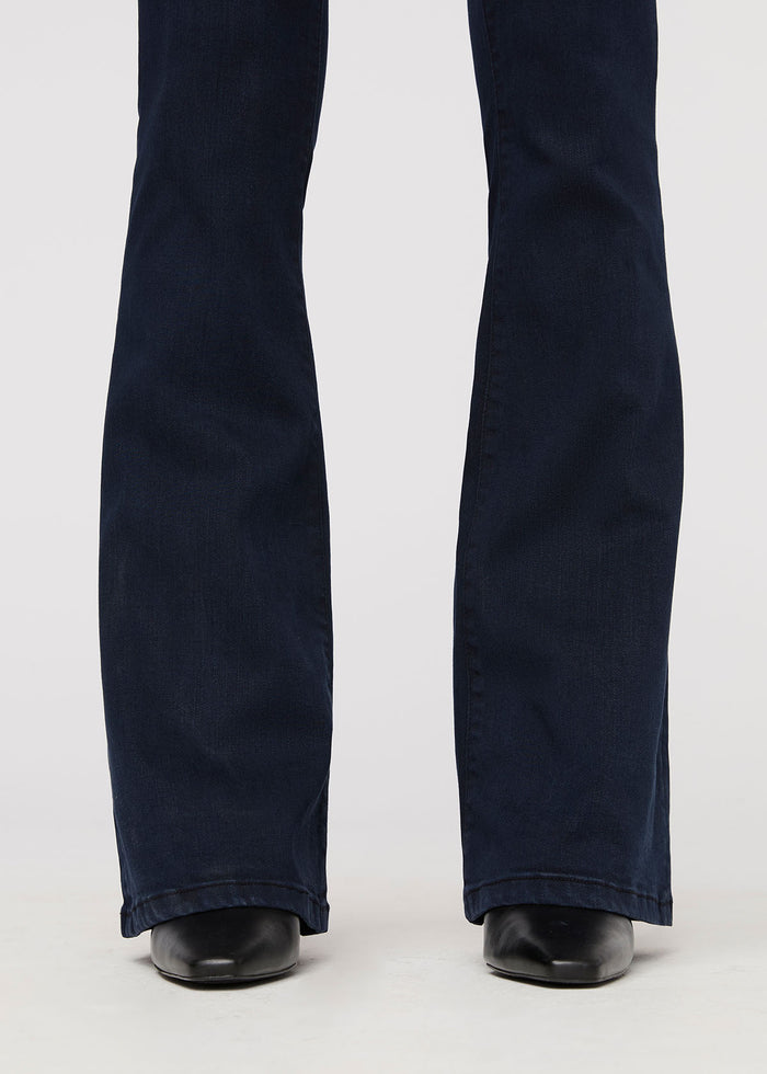 Dark blue denim flare pants with high rise waistband and wide leg opening at ankles.