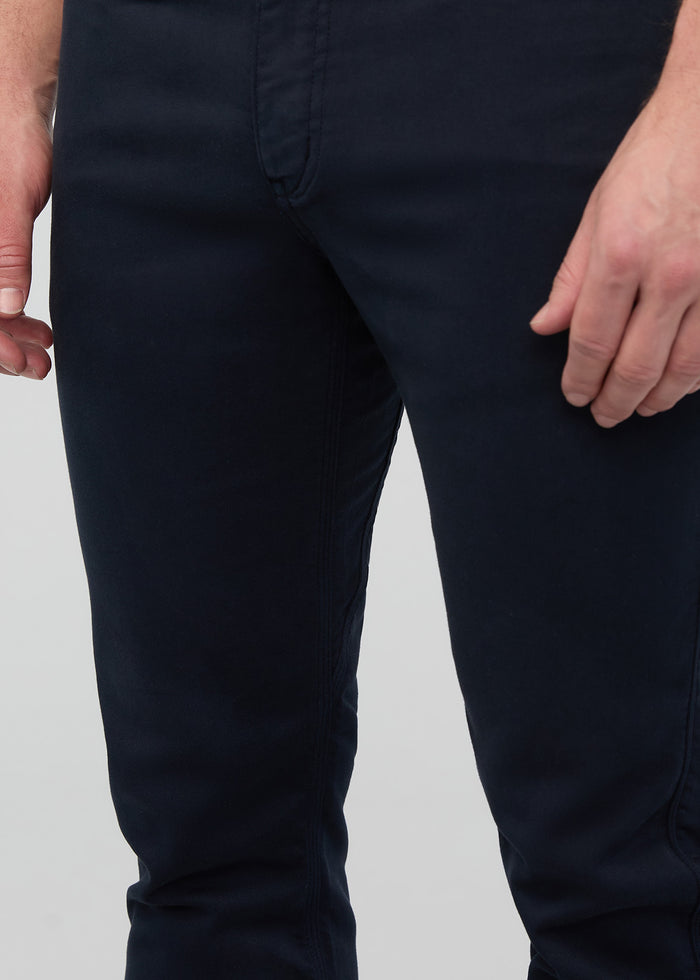Navy slim straight pants worn by model shown from waist down.