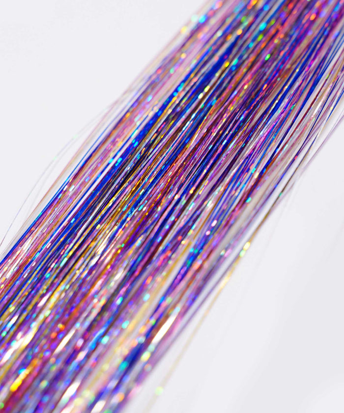 Close-up of Perfect Hair Tinsel by Perfect Locks in Pink Flamingo, with shiny iridescent strands adding vibrant sparkle to hair.#color_bubblegum