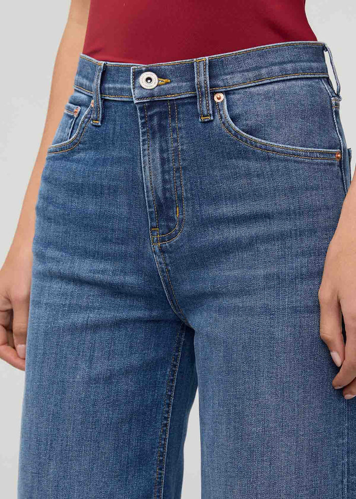 High-rise wide-leg crop denim in medium blue wash with visible stitching and button closure.