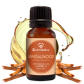 Bottle of sandalwood essential oil with a droplet effect on a white background