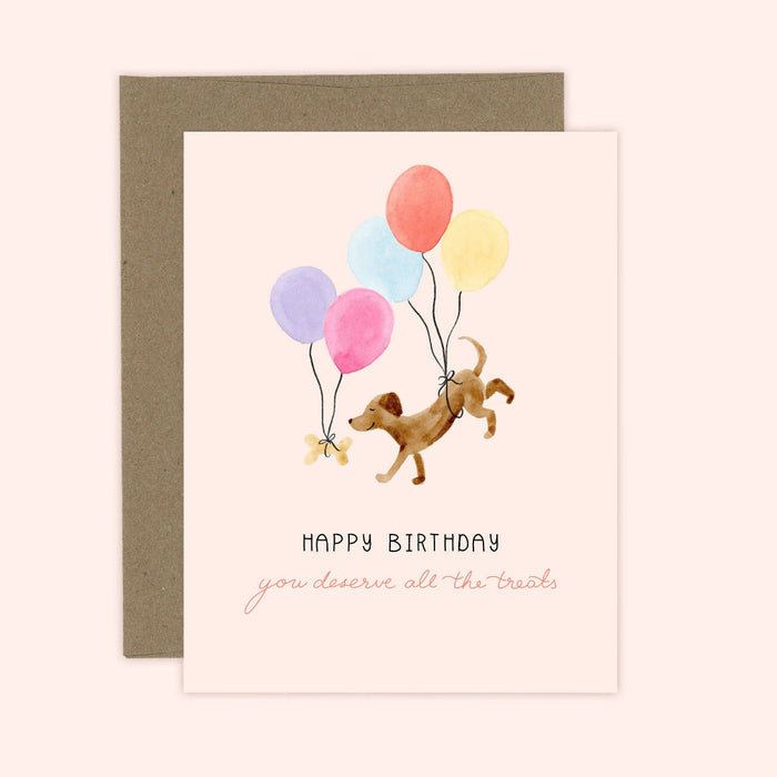Birthday card with a dog and balloons design on a beige background