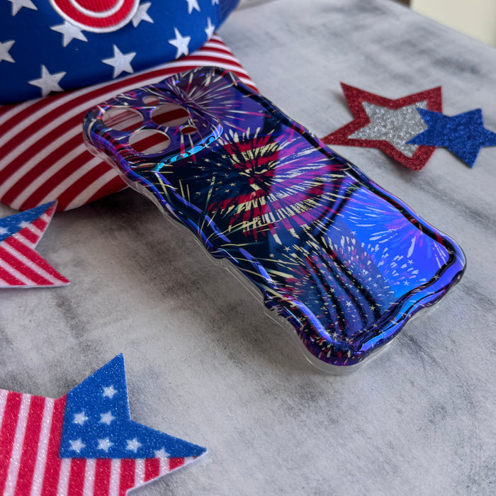Dark blue wavy iPhone case featuring bright red, white, and blue fireworks display held in hand.