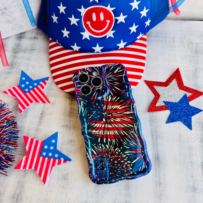 Dark blue wavy iPhone case featuring bright red, white, and blue fireworks display held in hand.